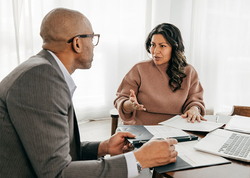 Financial advisor explaining trust management options to a client.
